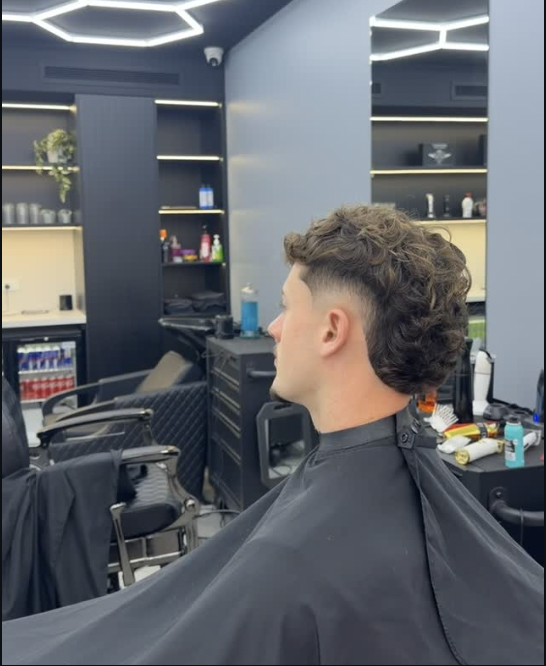 Curly taper fade in the barber chair